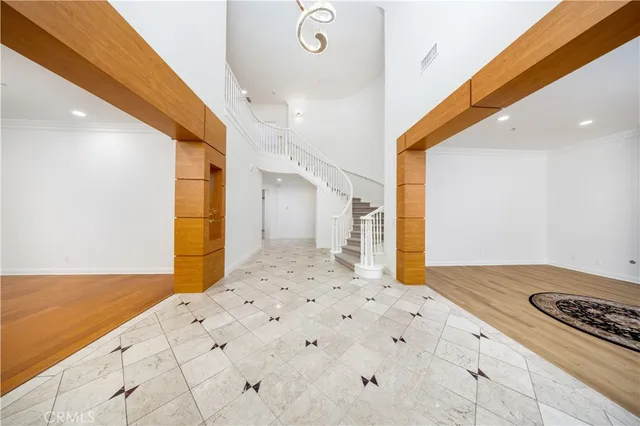 a bedroom with a large bed and a chandelier