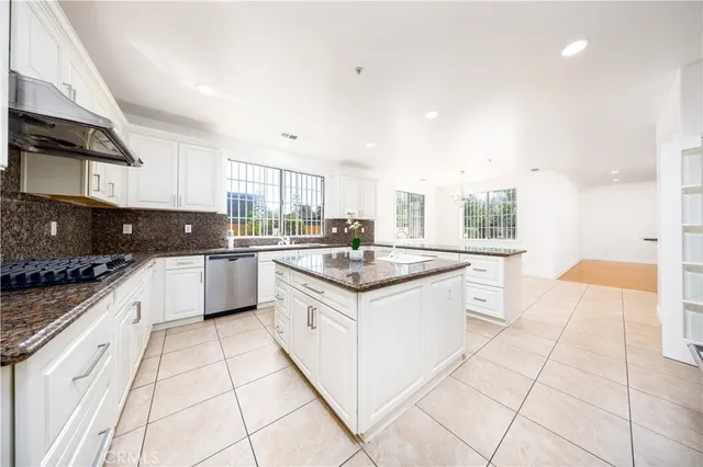 a kitchen with stainless steel appliances granite countertop a sink and a stove