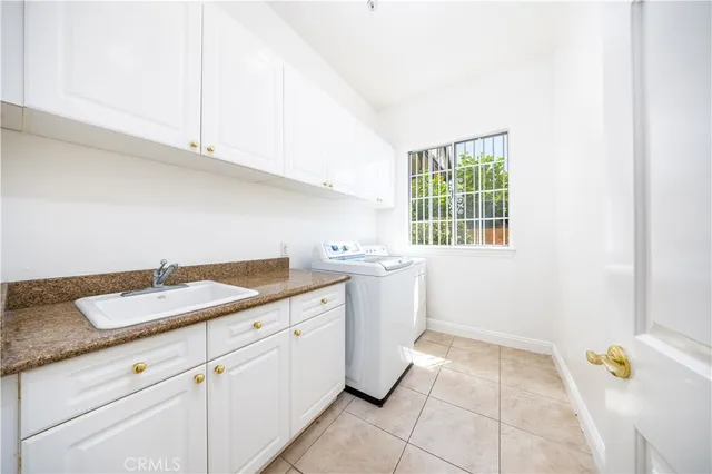 a utility room with a sink cabinets and utility