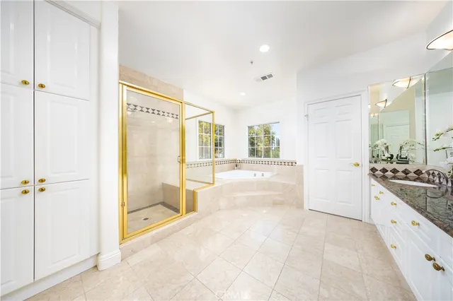 a bathroom with a granite countertop sink mirror and double