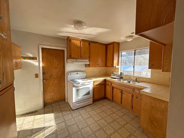 a kitchen with a sink cabinets and stainless steel appliances