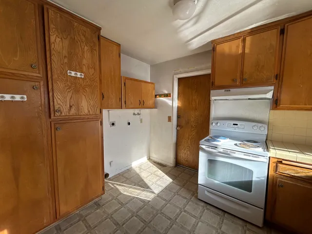 a kitchen with a refrigerator stove and cabinets
