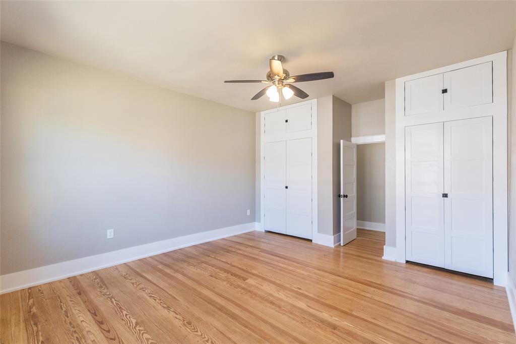 601 North Ave G Haskell, TX 79521 - Photo 27 of 36 an empty room with wooden floor fan and windows
