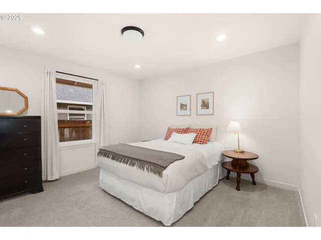 a bedroom with a bed and a dresser