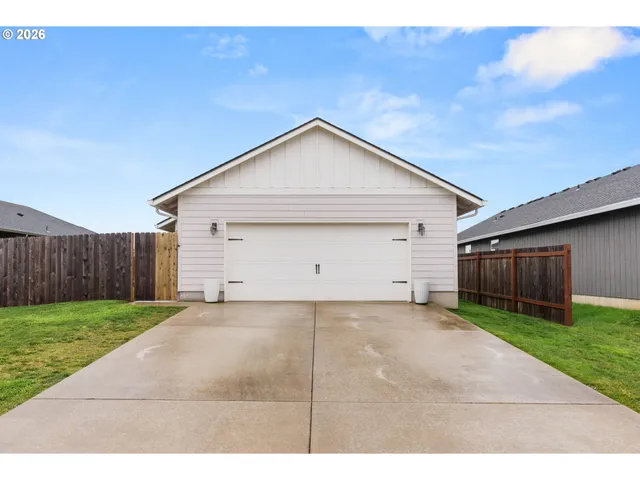 a view of a house with a yard and garage