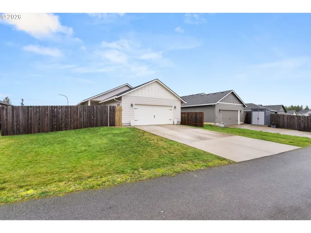 a house view with swimming pool in front of it