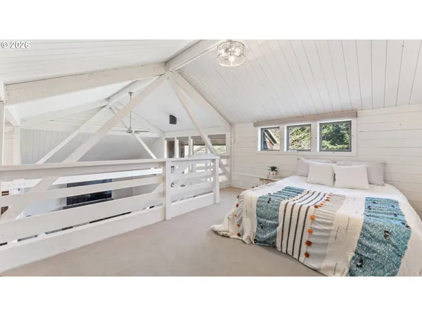 a living room with a bed and a large window