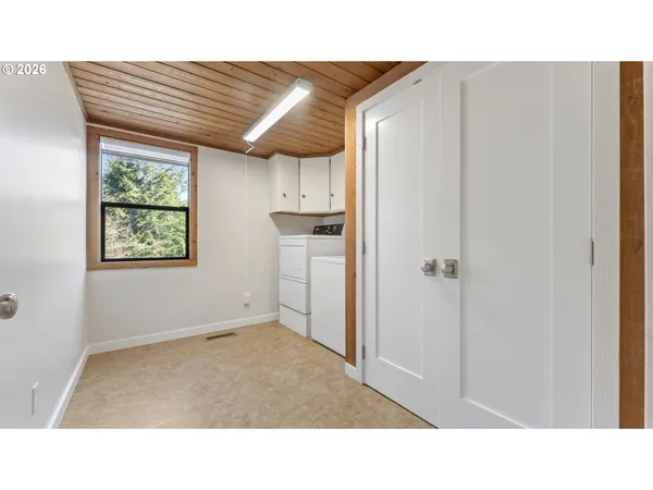 a open kitchen with a refrigerator and window