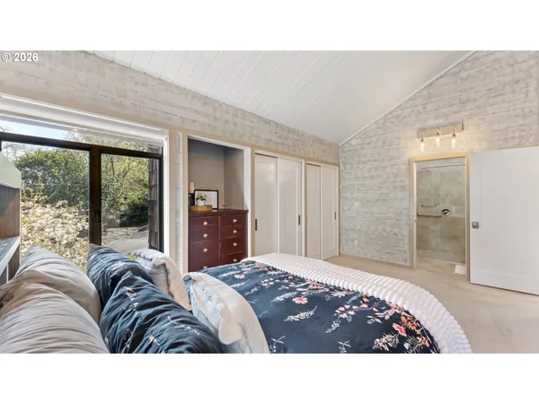 a living room with a bed furniture and a large window