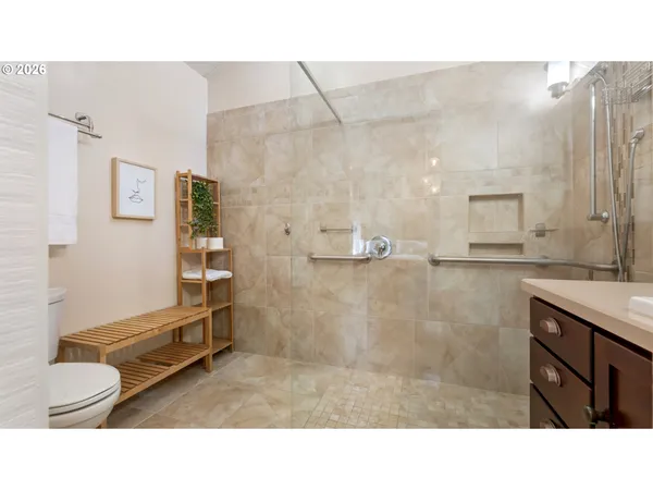 a bathroom with a sink a toilet and shower