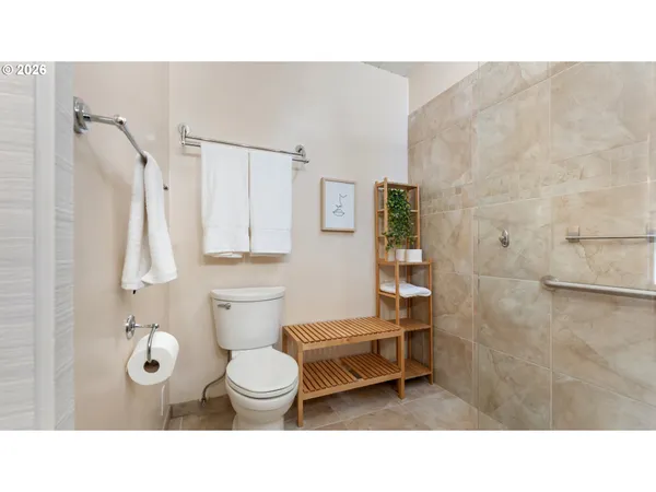 a bathroom with a toilet and a shower