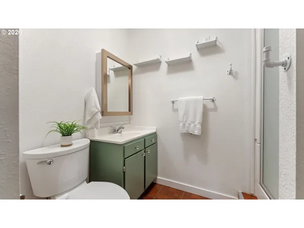 a bathroom with a sink toilet and mirror