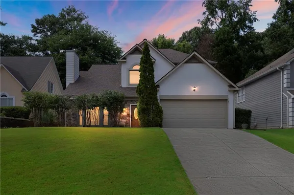 a front view of house with yard and green space