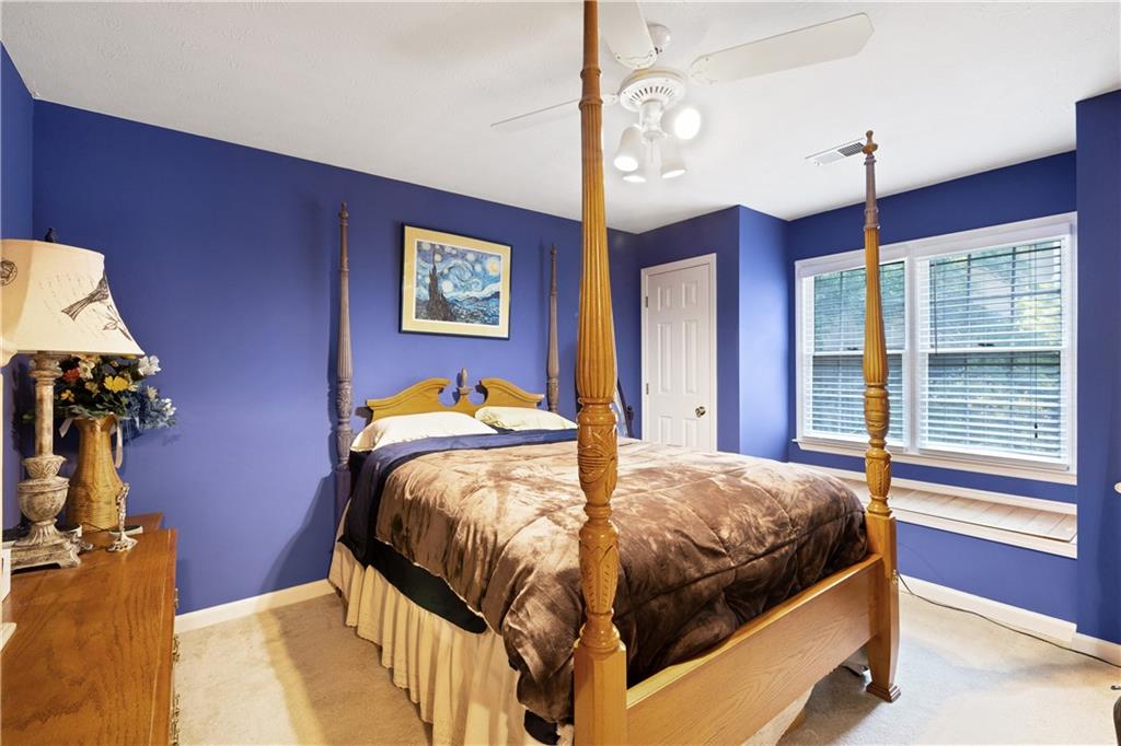 110 River Terrace Point Roswell, GA 30076 - Photo 18 of 24 a bedroom with a bed and a chandelier