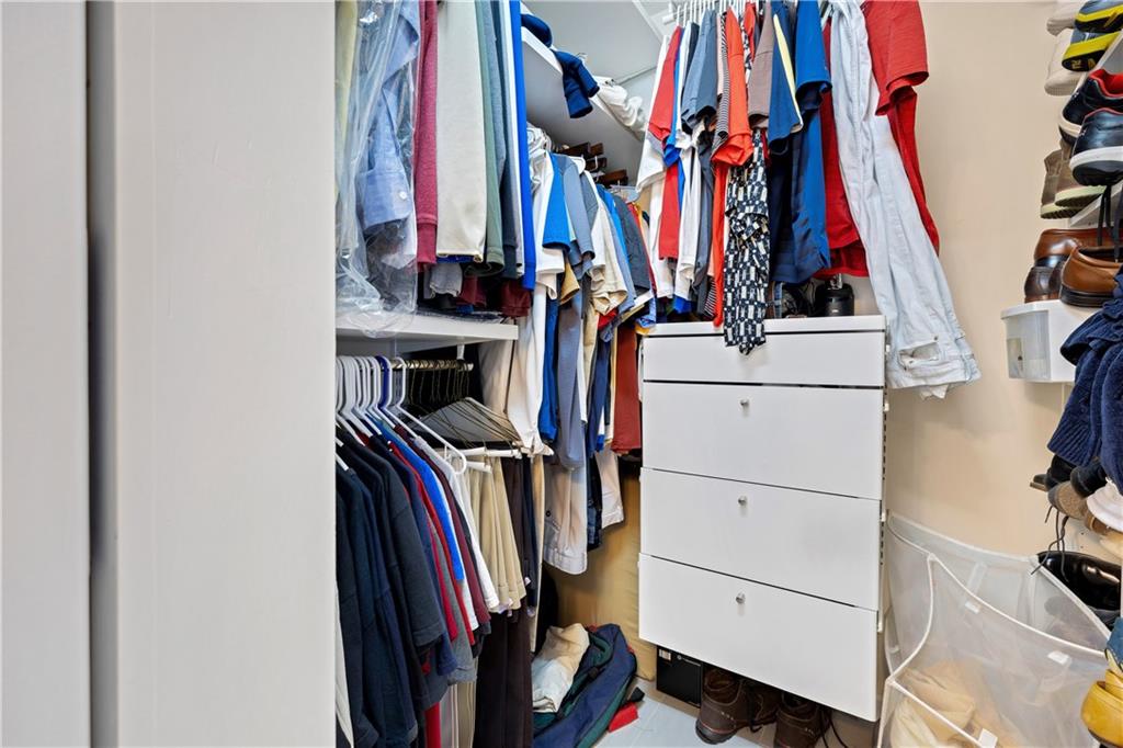 110 River Terrace Point Roswell, GA 30076 - Photo 19 of 24 a view of walk in closet with clothes and shoes