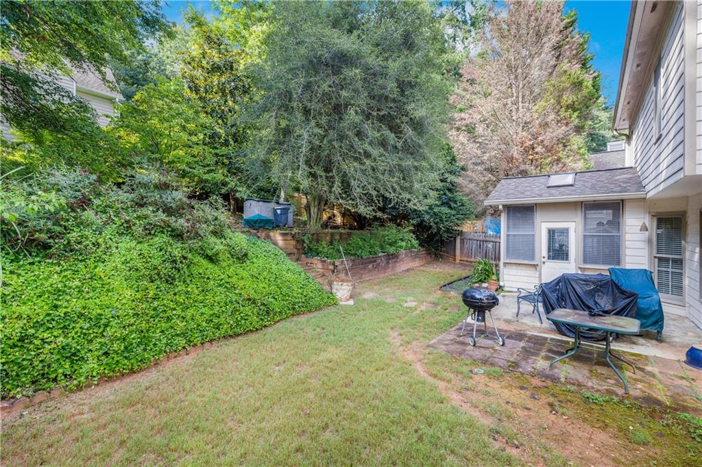 110 River Terrace Point Roswell, GA 30076 - Photo 23 of 24 a view of a backyard with table and chairs and potted plants