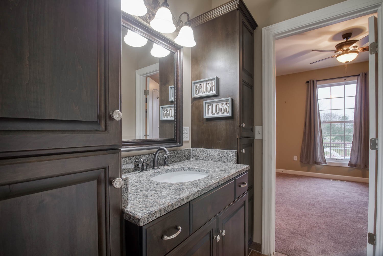 197 Turner Road Watertown, TN 37184 - Photo 26 of 65 a bathroom with a granite countertop sink a light fixture and a mirror