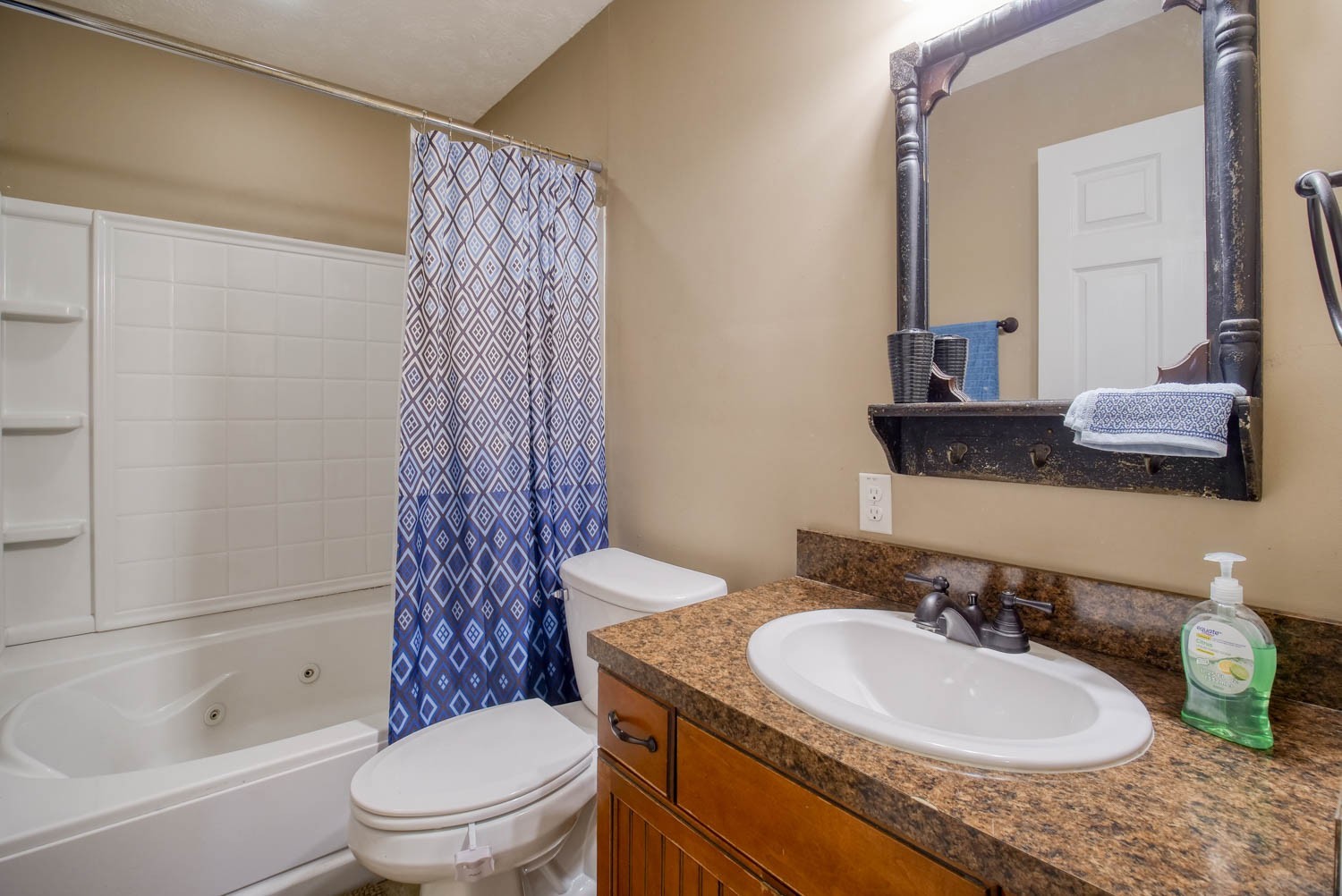 197 Turner Road Watertown, TN 37184 - Photo 38 of 65 a bathroom with a granite countertop sink toilet a mirror a bathtub and shower