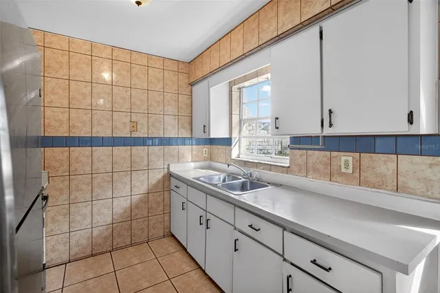a kitchen with a sink and cabinets