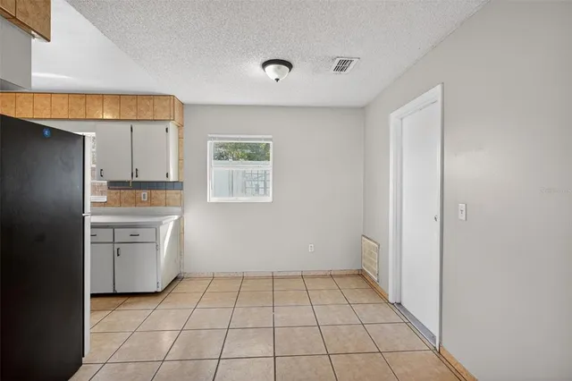 a kitchen with granite countertop a refrigerator and a sink