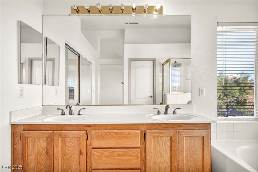 1704 Jack Rabbit Way Las Vegas, NV 89128 - Photo 16 of 25 Full bath with a garden tub, double vanity, and a shower stall