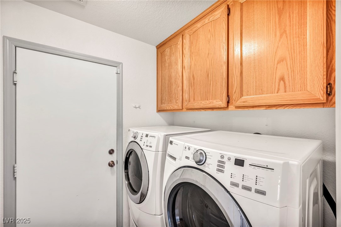 1704 Jack Rabbit Way Las Vegas, NV 89128 - Photo 8 of 25 Laundry area featuring separate washer and dryer, cabinet space, and a textured ceiling