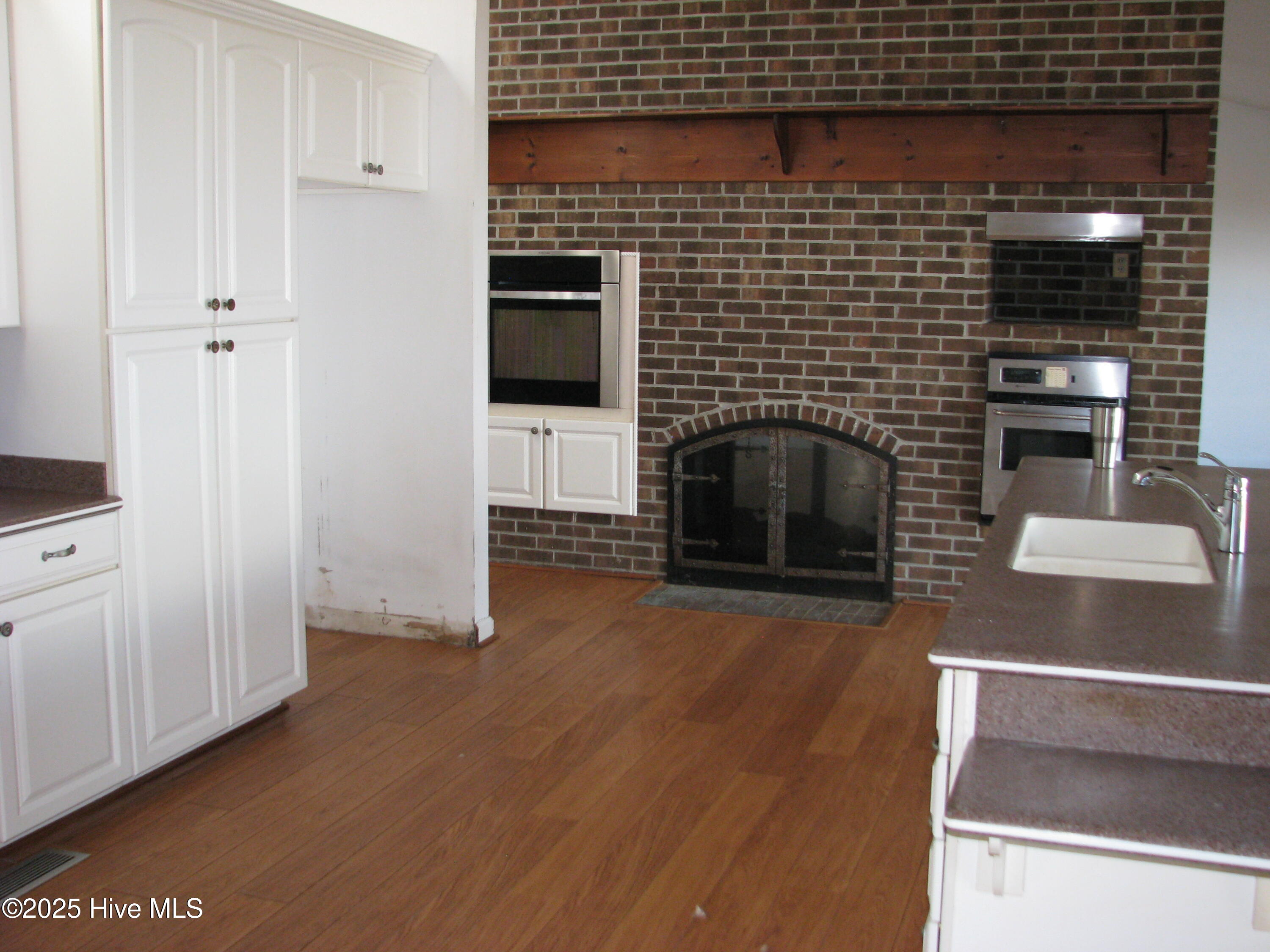 227 Rhodes Drive Columbia, NC 27925 - Photo 16 of 24 View of fireplace between kitchen and formal LR