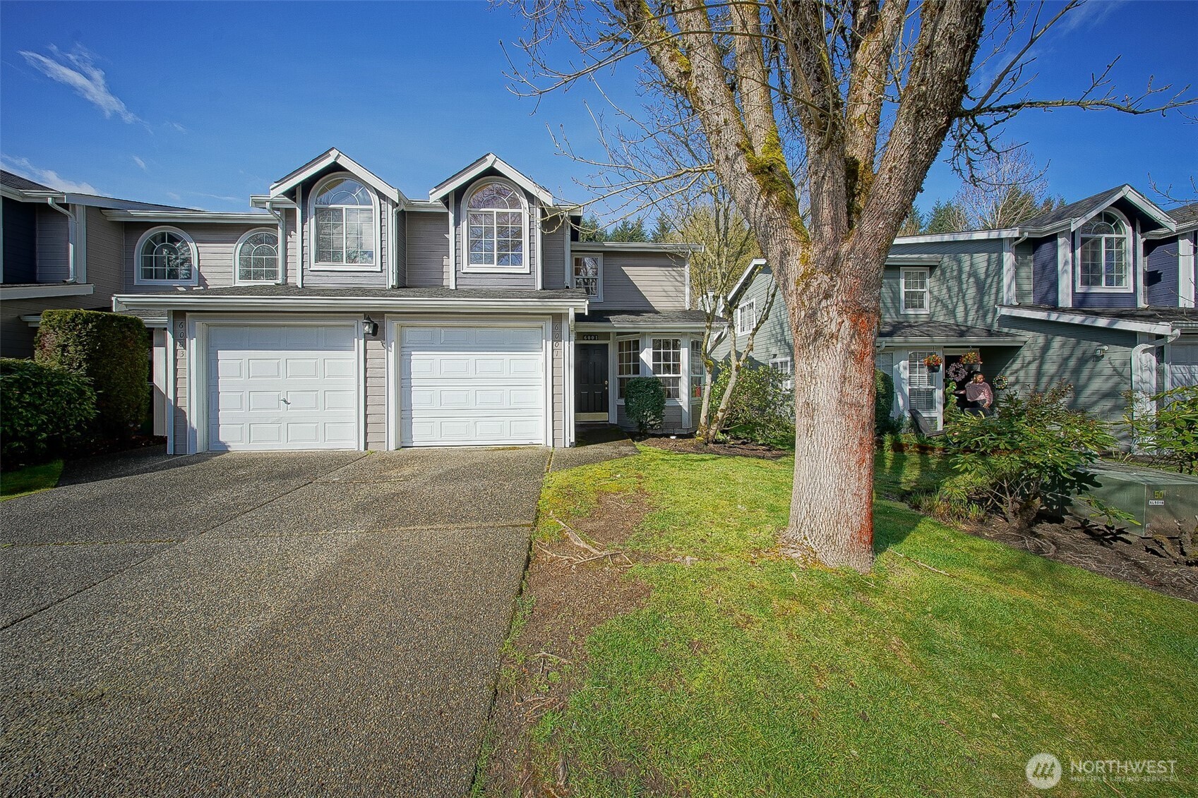 a front view of a house with a yard and garage