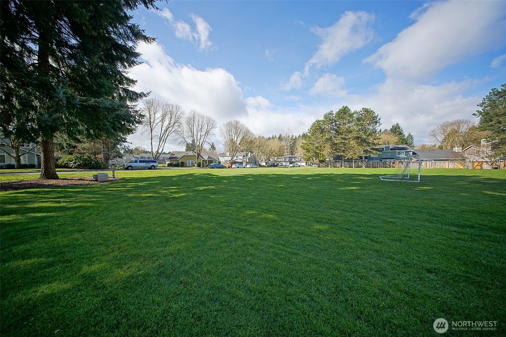 6001 Merlot Lane Southeast Lacey, WA 98513 - Photo 32 of 40 a backyard of apartments with large trees
