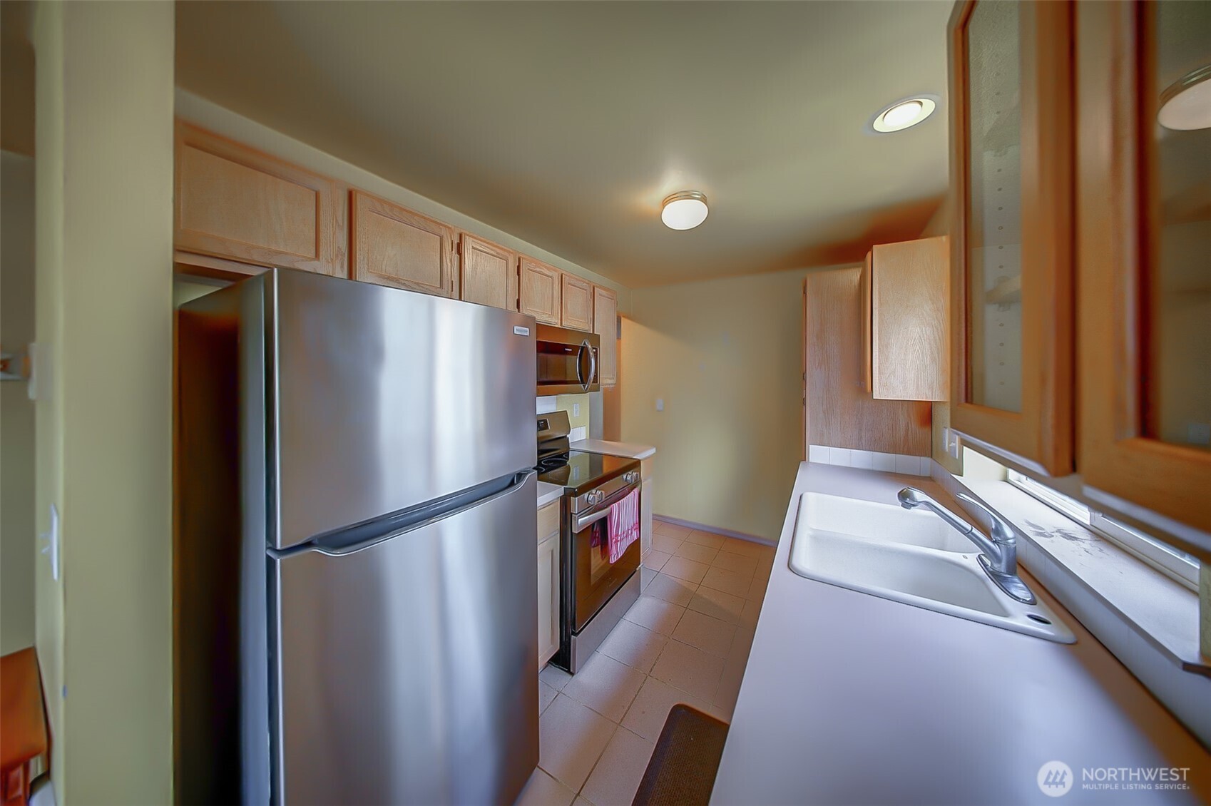 6001 Merlot Lane Southeast Lacey, WA 98513 - Photo 6 of 40 a kitchen with stainless steel appliances a refrigerator and a sink