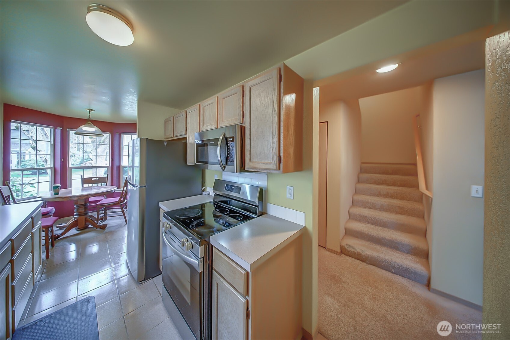 6001 Merlot Lane Southeast Lacey, WA 98513 - Photo 9 of 40 a kitchen that has a lot of cabinets a sink and a stove in it
