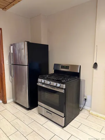 a stove top oven sitting inside of a kitchen