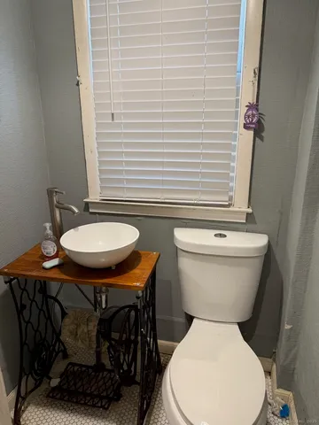 a white toilet sitting next to a bathroom sink