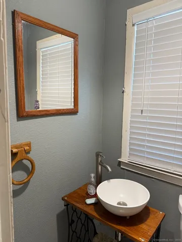 a bathroom with a sink a mirror and a toilet