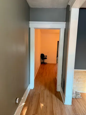 a view of a room with wooden floor and a window