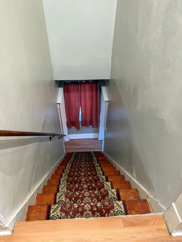 a view of a room with wooden floor