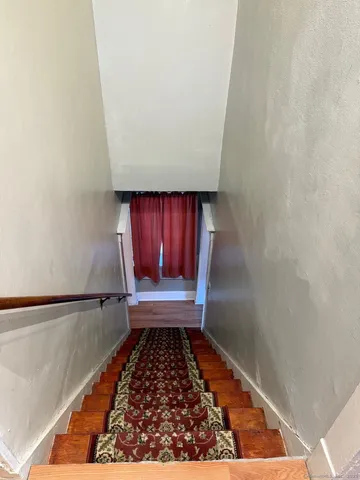 a bathroom with a toilet a sink and a window