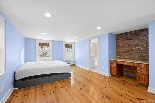 a spacious bedroom with a bed and a fireplace