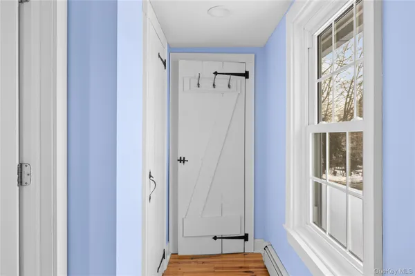 a view of front door with wooden floor