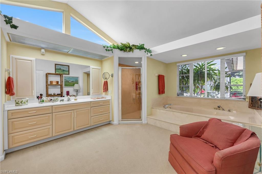 737 Anchor Rode Drive Naples, FL 34103 - Photo 11 of 21 Bathroom with plenty of natural light, a stall shower, vanity, a bath, and lofted ceiling