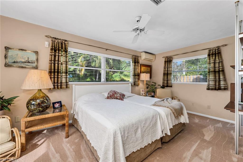 737 Anchor Rode Drive Naples, FL 34103 - Photo 13 of 21 Bedroom with ceiling fan, carpet floors, and a wall mounted air conditioner