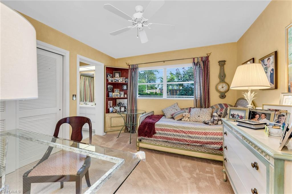 737 Anchor Rode Drive Naples, FL 34103 - Photo 15 of 21 Bedroom featuring light carpet, ceiling fan, a desk, and a closet