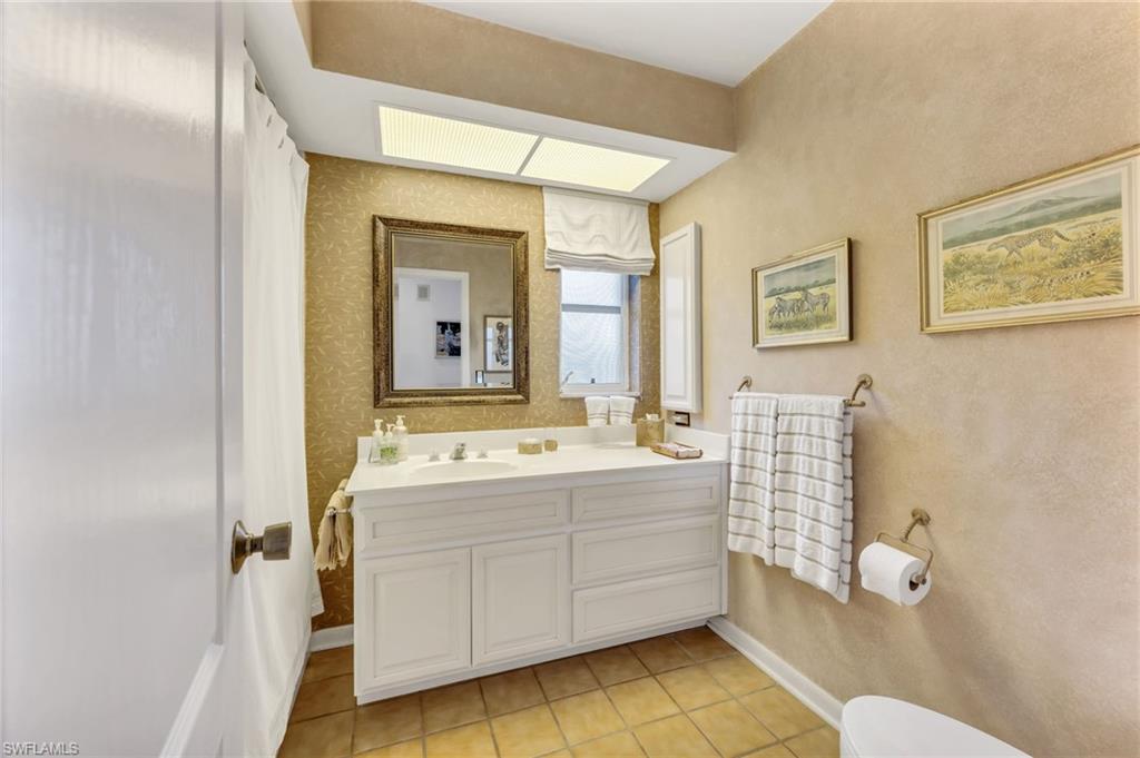 737 Anchor Rode Drive Naples, FL 34103 - Photo 16 of 21 Bathroom with vanity, light tile patterned floors, and a shower with curtain