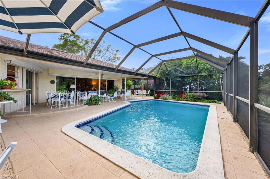 737 Anchor Rode Drive Naples, FL 34103 - Photo 21 of 21 Swimming pool featuring glass enclosure, a patio area, and a sunroom