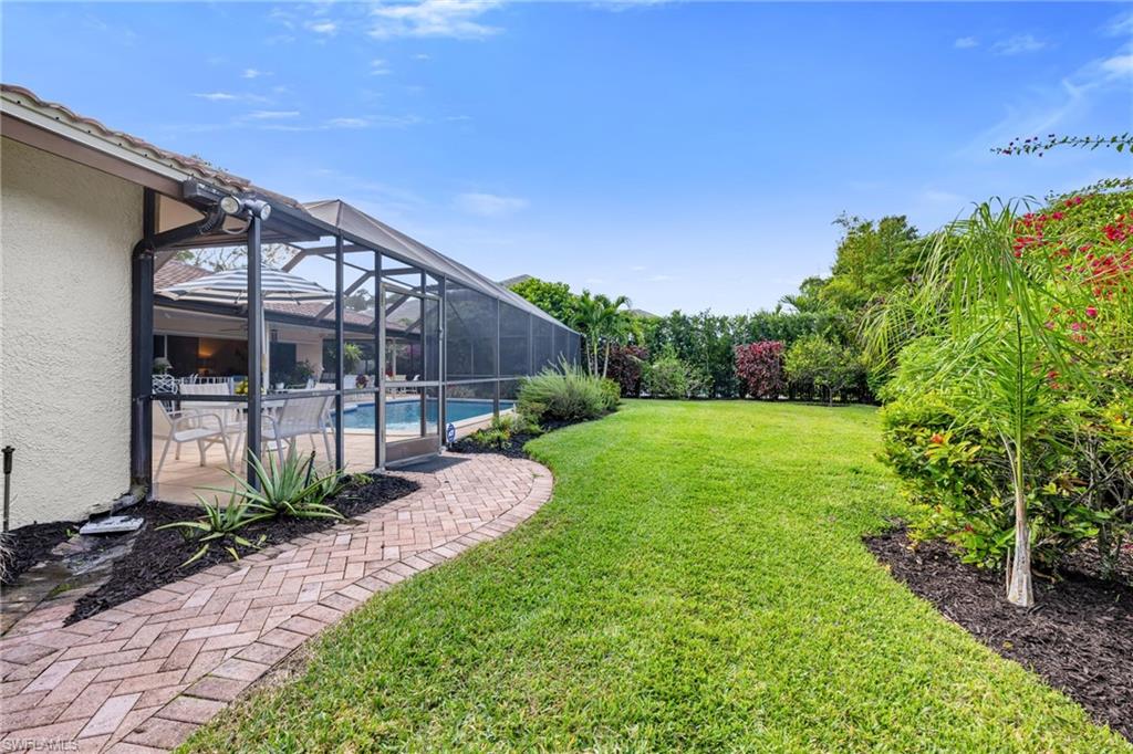 737 Anchor Rode Drive Naples, FL 34103 - Photo 3 of 21 View of grassy yard featuring an outdoor pool, a lanai, a sunroom, and a patio