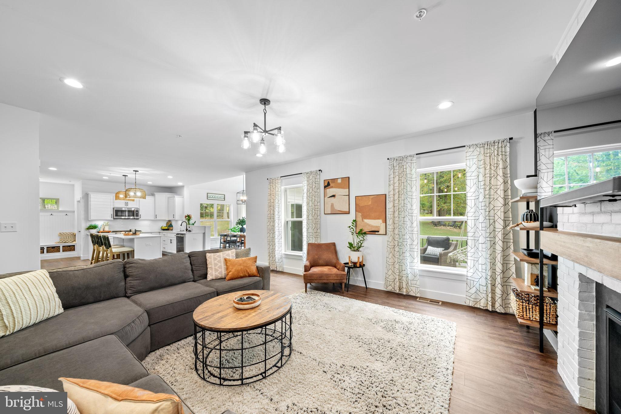 611 Grouse Road Exton, PA 19341 - Photo 21 of 59 a living room with furniture a fireplace and a large window