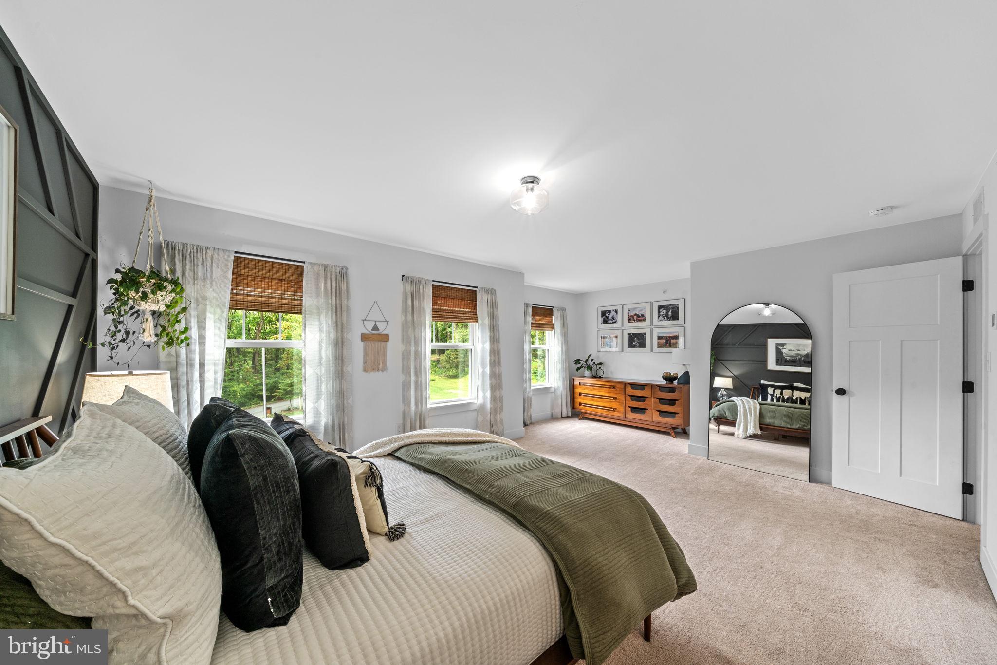 611 Grouse Road Exton, PA 19341 - Photo 29 of 59 a bedroom with a bed and a large window with the outer view