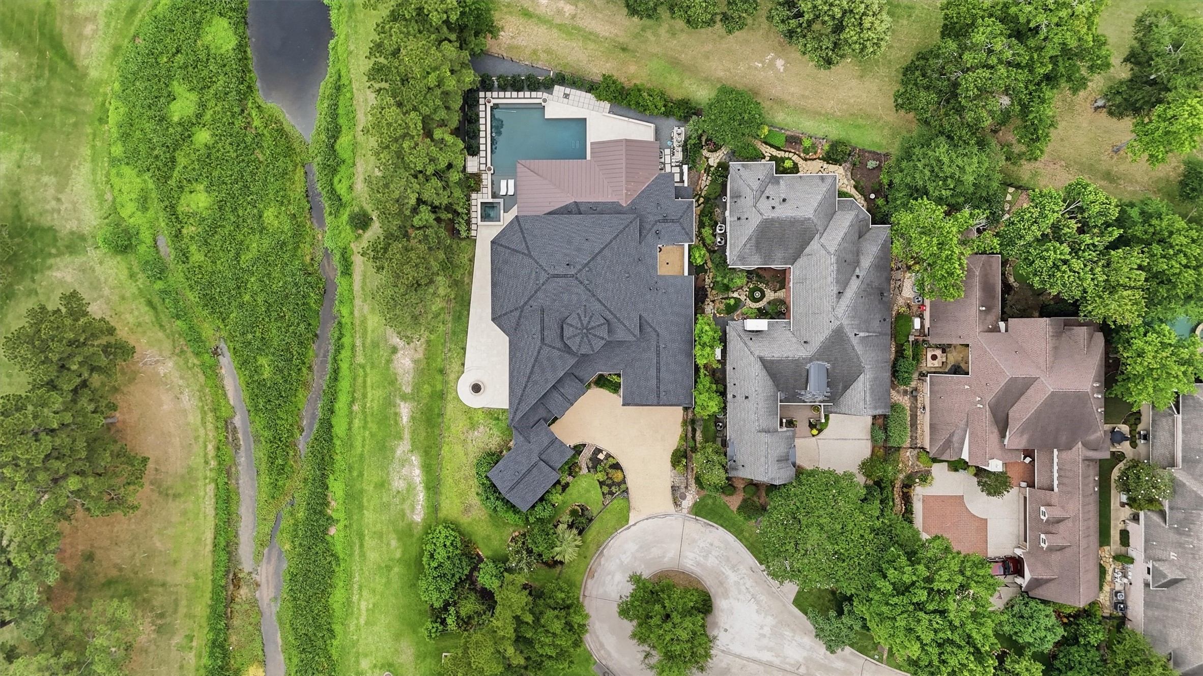 70 Quail Rock Place The Woodlands, TX 77381 - Photo 42 of 46 an aerial view of residential house with outdoor space and trees all around