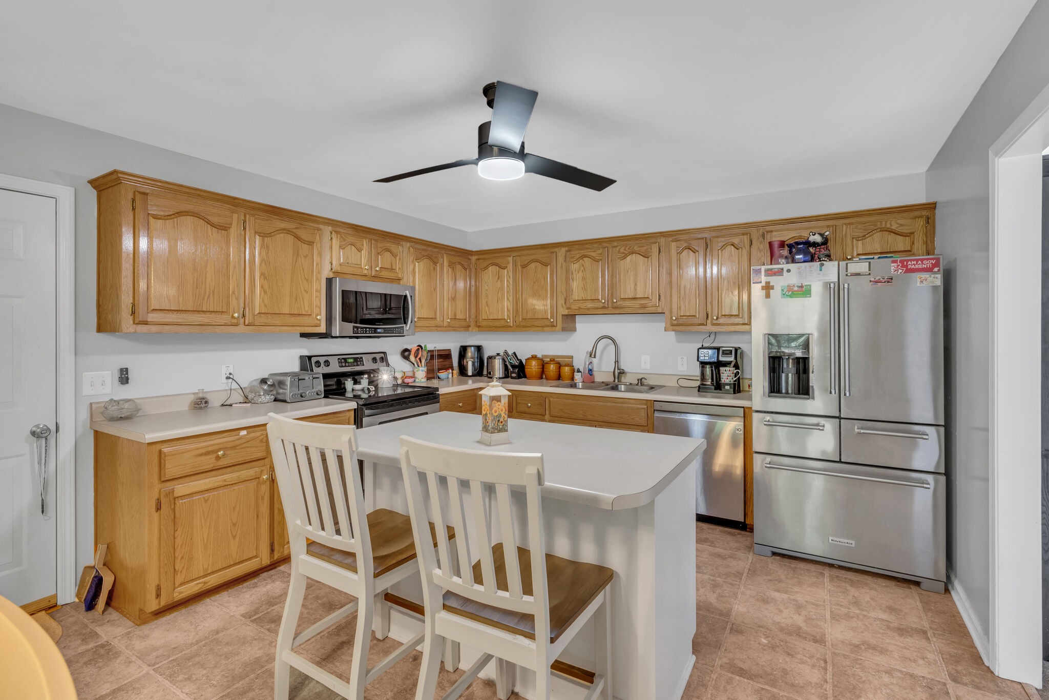 156 Foxrun Springfield, TN 37172 - Photo 14 of 31 a kitchen with stainless steel appliances granite countertop a refrigerator a stove top oven a sink dishwasher and white cabinets with wooden floor