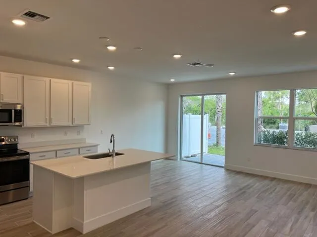 a kitchen with a sink and large window